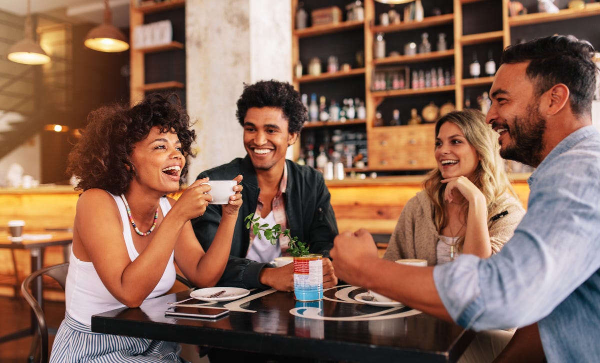 Students in a coffee shop chatting in Italian after their language class with Berlitz Algeria