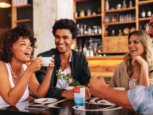Students in a coffee shop chatting in Italian after their language class with Berlitz Algeria