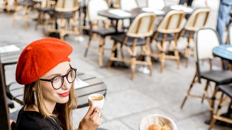 Woman drinking coffee after attending he French class with Berlitz Algeria
