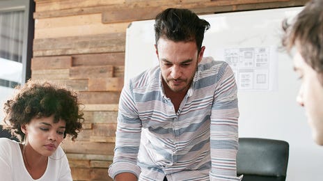 Students looking at notes together during a business language training with Berlitz Algeria