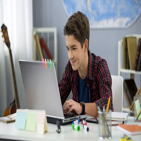 Kid attending an online German class with Berlitz from his laptop