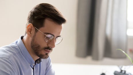 Man in front of his computer preparing for his IELTS exam