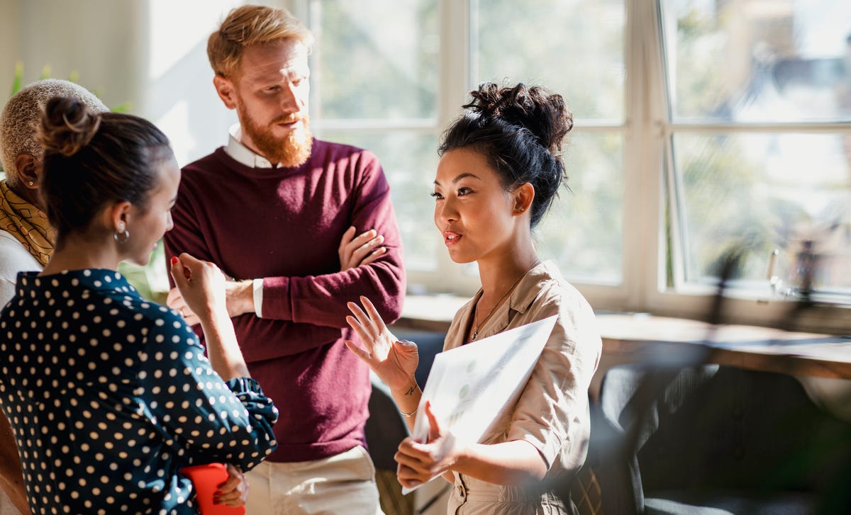 Group of students discussing the material during an IELTS exam preparation course