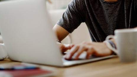 Man taking an online English course with Berlitz Algeria from his laptop