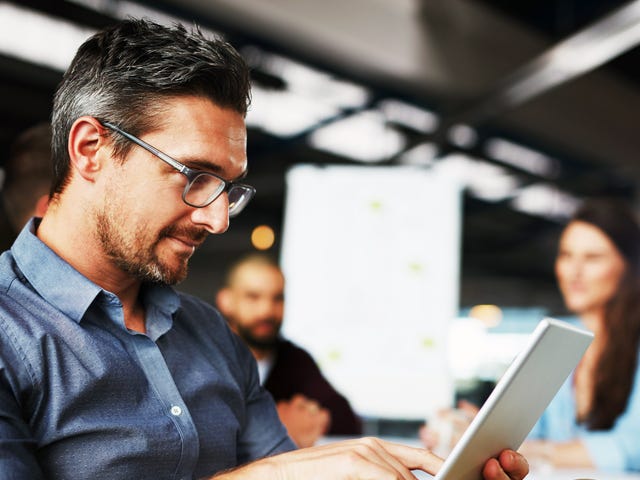 Man on his tablet exercising his language skills with Berlitz Algeria's self-study program in his workplace