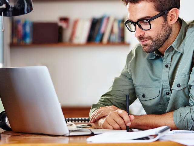 Man taking an online intensive course with Berlitz from his laptop