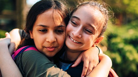 Children hugging each other before going to a summer language camp with Berlitz Algeria