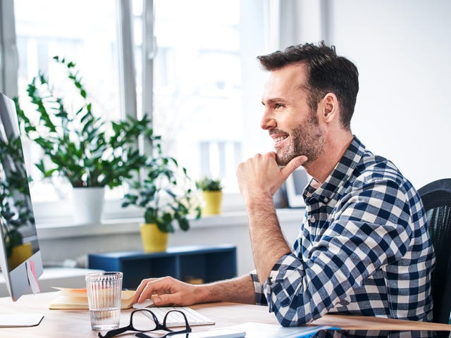 Man in front of a computer learning a language individually with Berlitz Flex