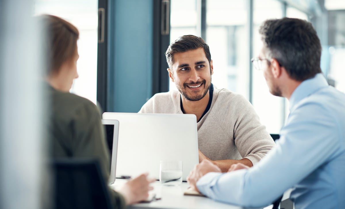 A Berlitz instructor talking to his students during a language class