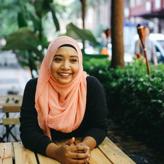 Woman sitting outside a coffee shop after her IELTS preparation course with Berlitz Algeria