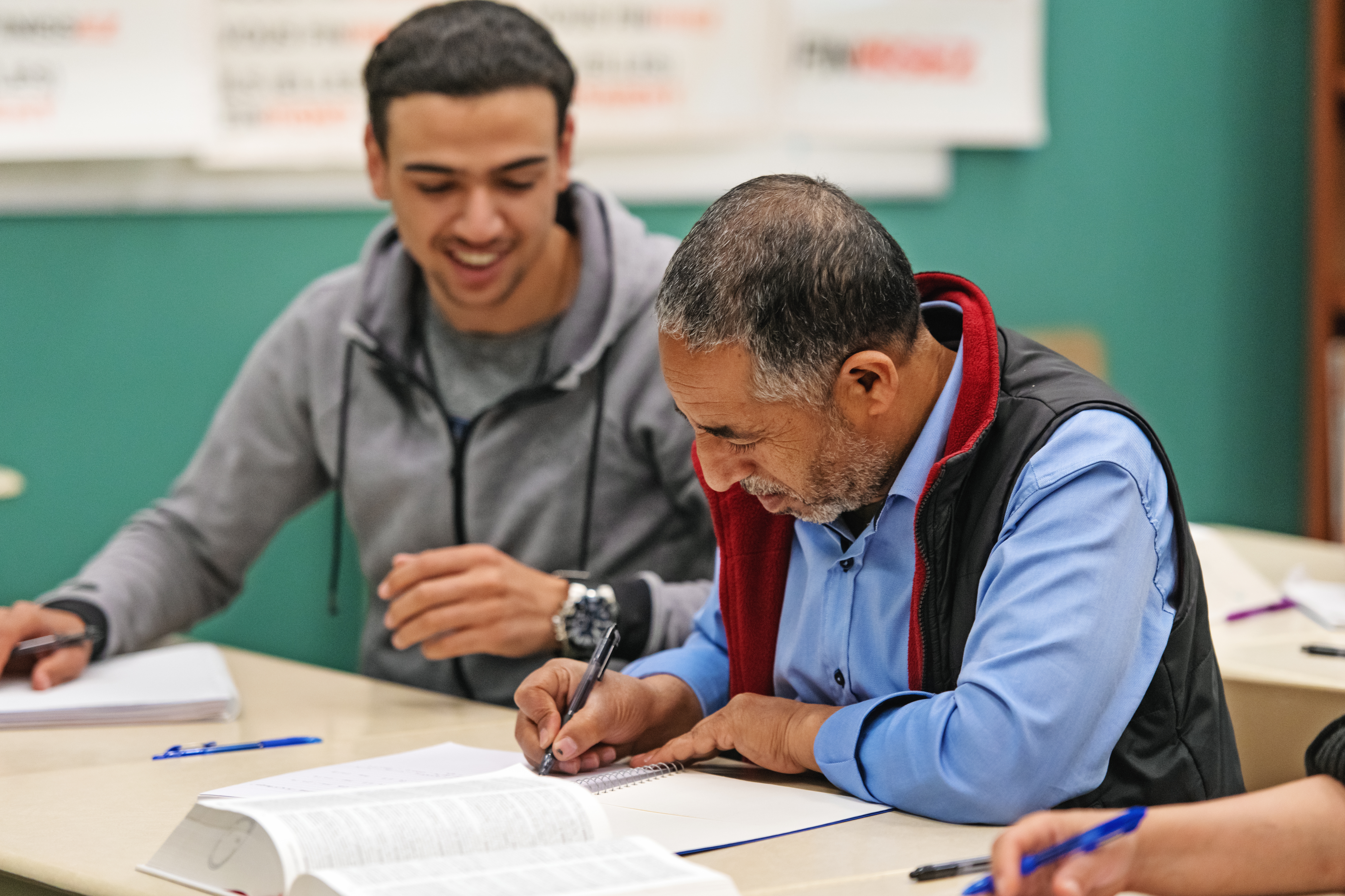 Students making notes and preparing for their language assessment with Berlitz Algeria