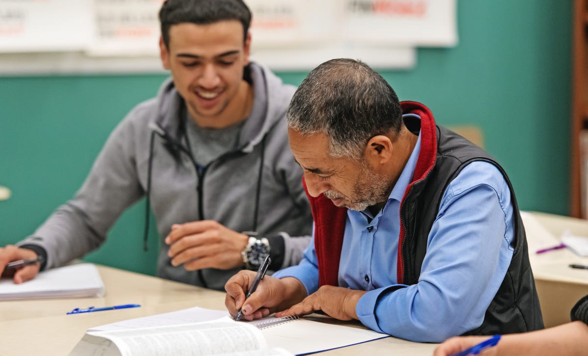 Students making notes and preparing for their language assessment with Berlitz Algeria