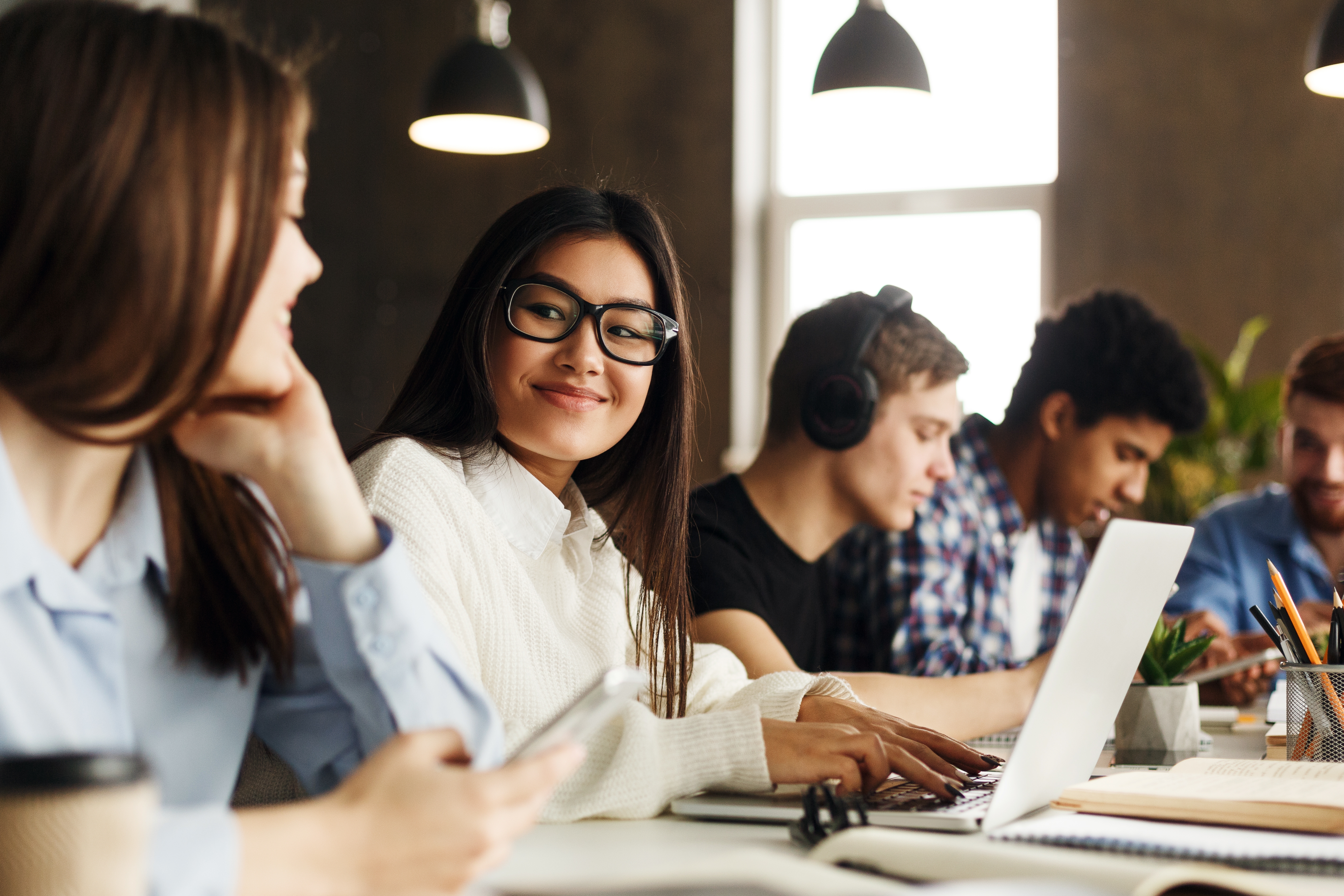 A group of teenagers in an Arabic class with Berlitz Algeria typing on their computers