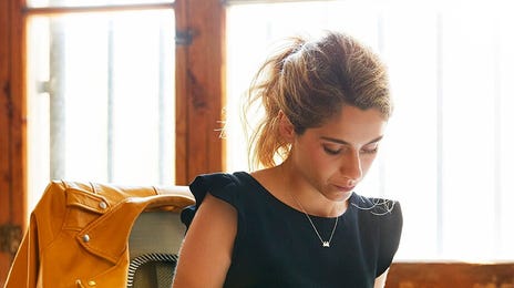 Woman making notes after her Business English class with Berlitz Algeria