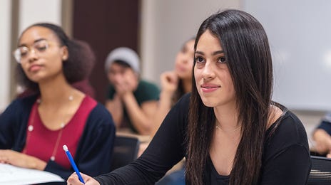 Students making notes during a group language course with Berlitz Algeria