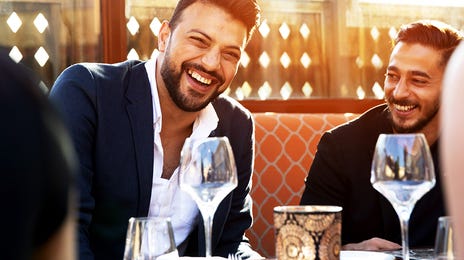Man speaking Spanish with his friends after his language class with Berlitz Algeria