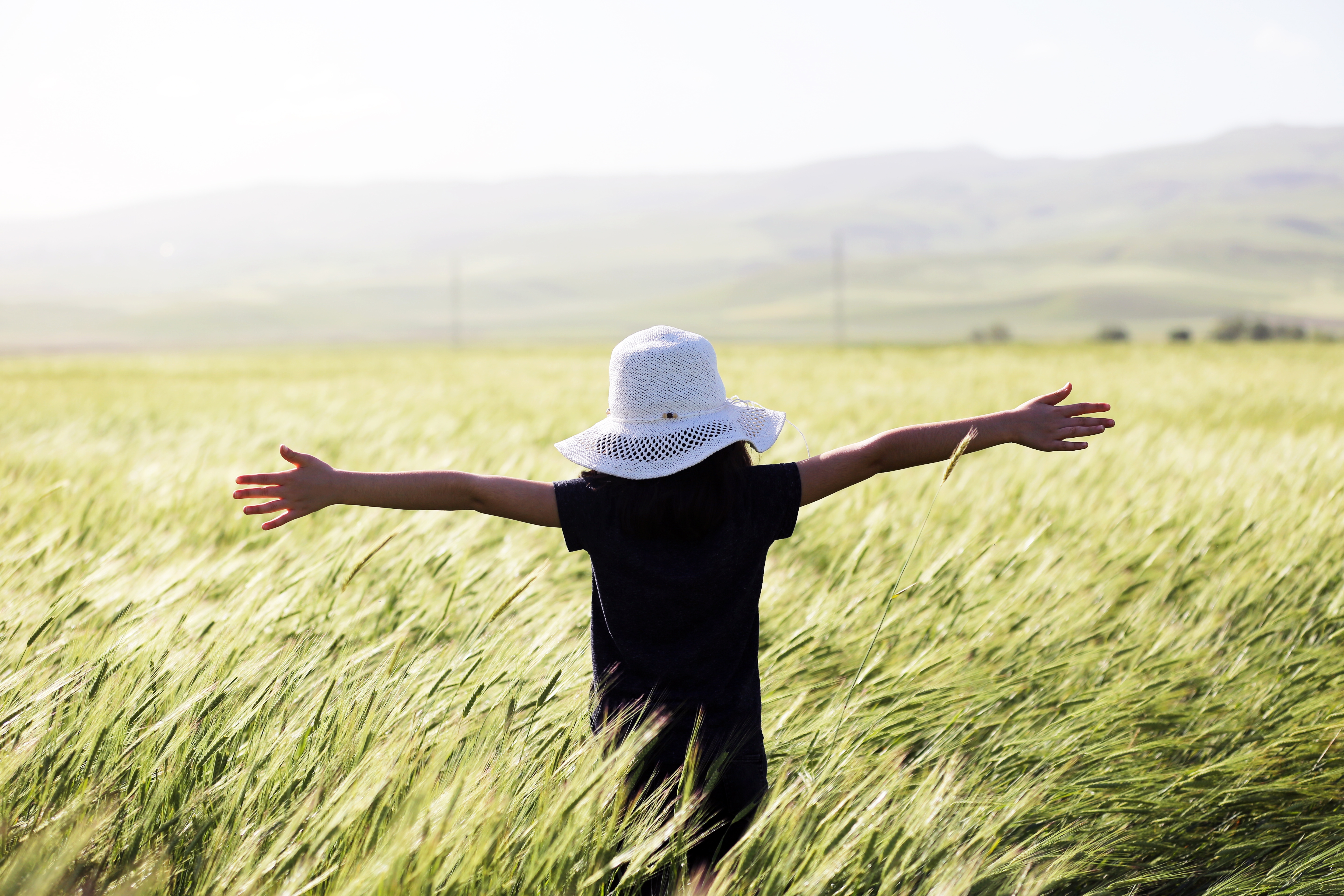 Woman in a field during traveling the world