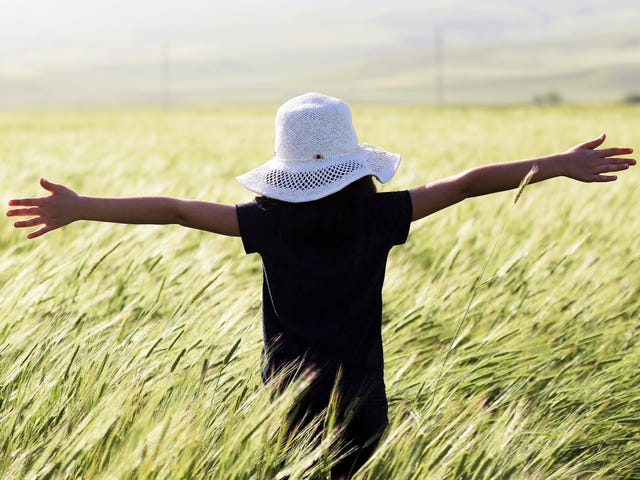 Woman in a field during traveling the world