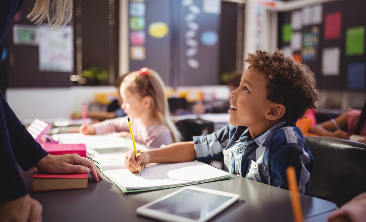 Boy making notes during his English course for kids and teens with Berlitz