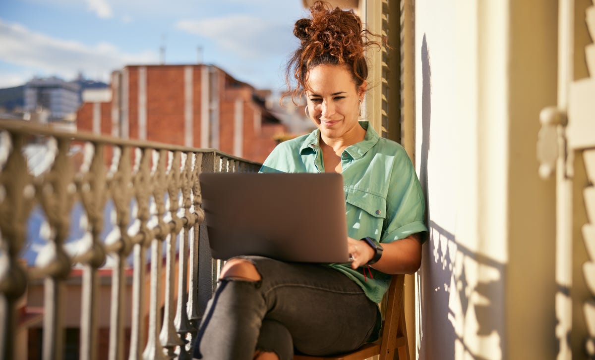 Woman in front of a laptop taking Berlitz's online language placement test