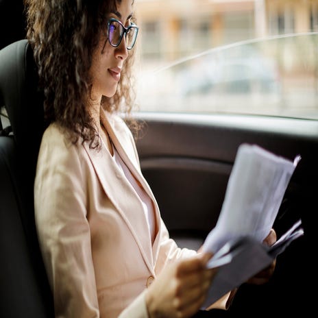 Woman studying business English in a car