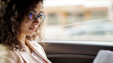 Woman studying business English in a car