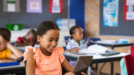 Girl using a tablet during a group English class with Berlitz Algeria
