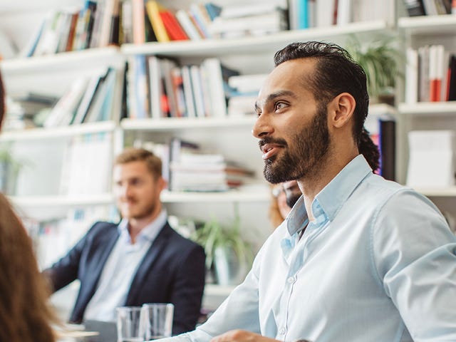 Man taking an international management class in a group setting with Berlitz Algeria