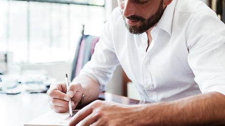Man taking notes during learning French with Berlitz