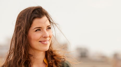 Smiling woman outside learning about cultures through immersion