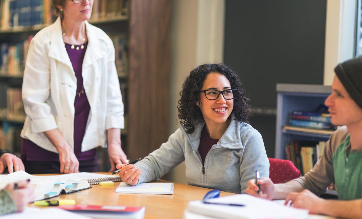 Woman making notes and listening to her instructor during an Arabic language class with Berlitz Algeria