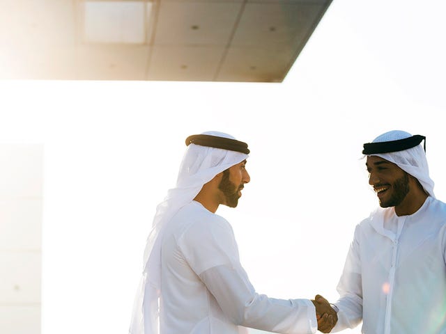 Man shaking hands and talking professional Arabic after their language course with Berlitz Algeria