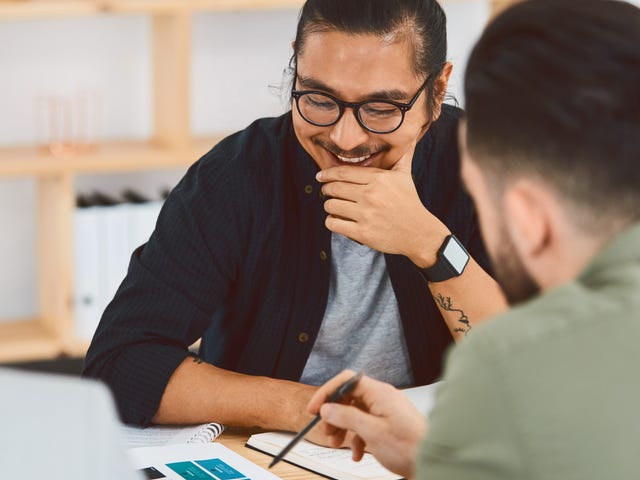 A student watching what their instructor shows him during a foreign language lesson