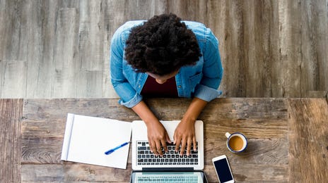 Student making notes on his laptop during an online language group course with Berlitz Algeria