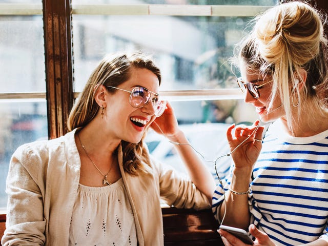 Women listening to music together and talking about Berlitz