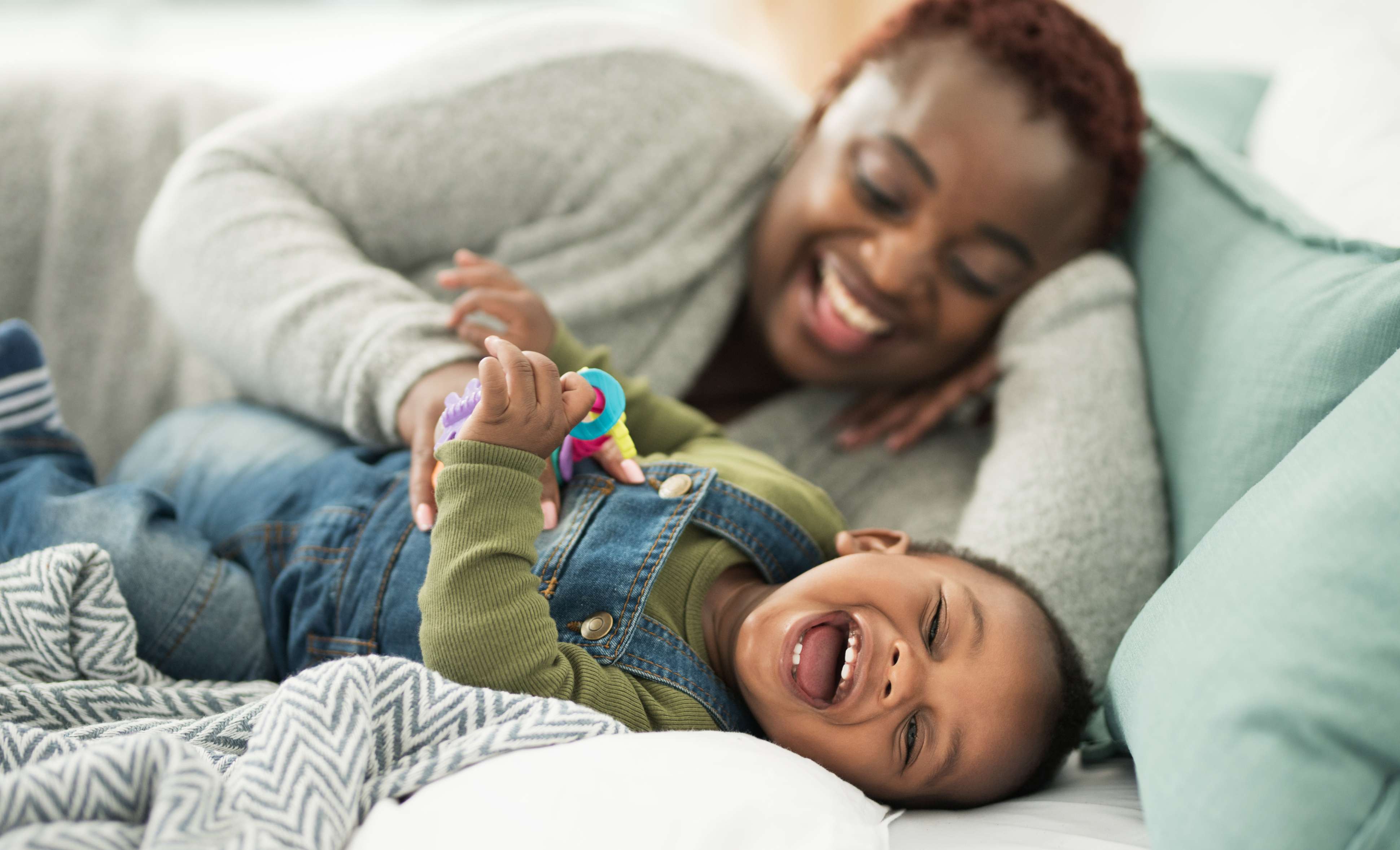 Mother and toddler laughing
