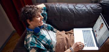 A young girl sits on her couch while having a virtual consult with her St. Luke's doctor.