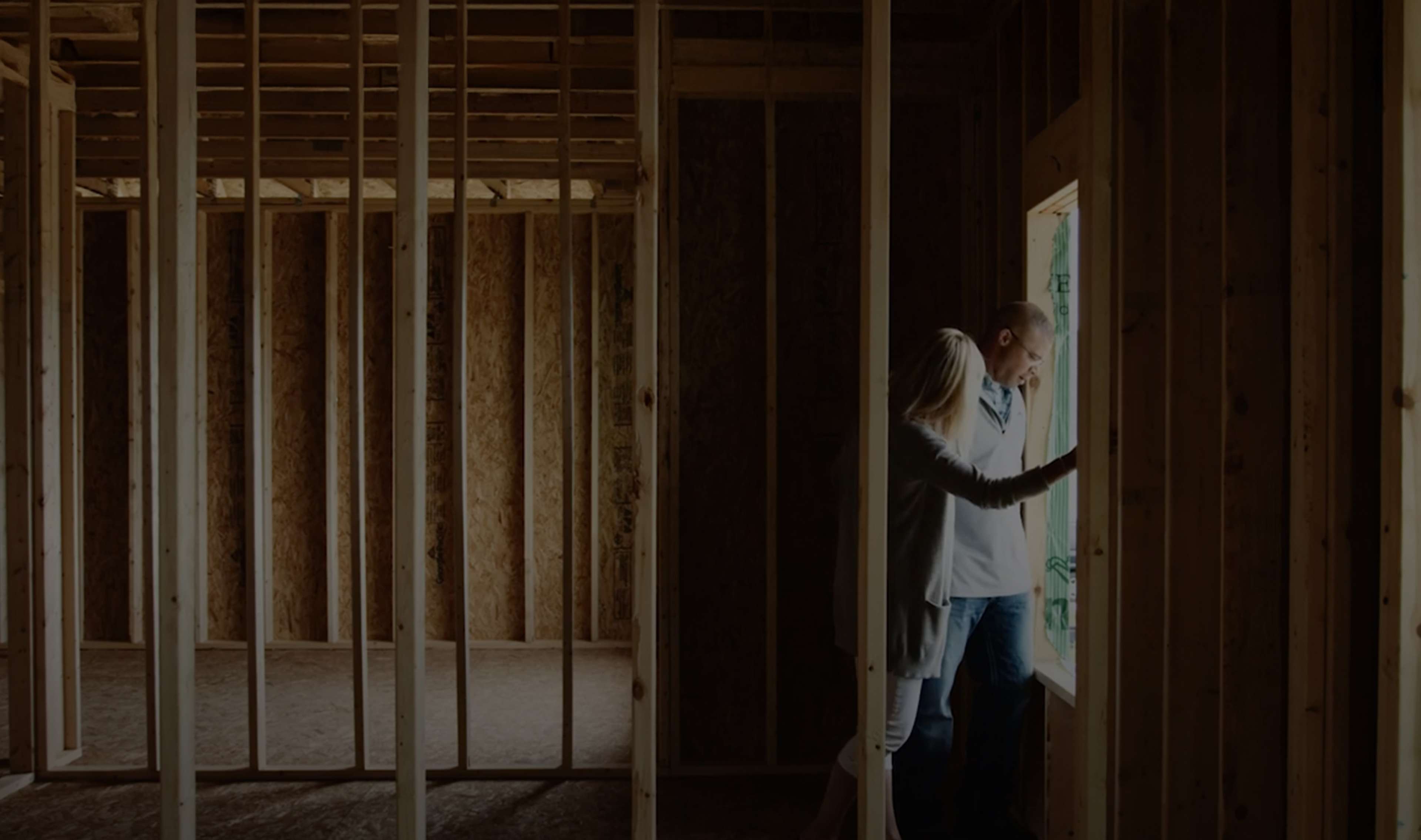 Couple walking through an under construction home.