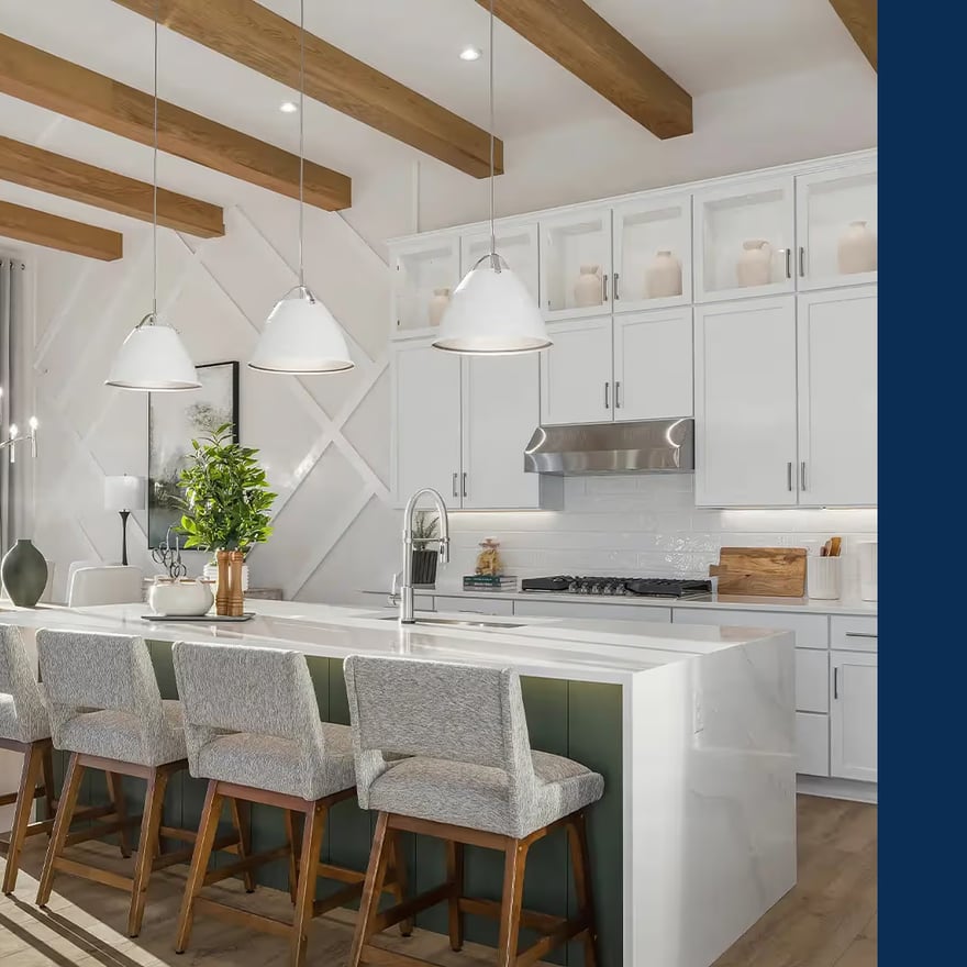 A modern kitchen features a large island with bar seating, white cabinets, and wooden beams. A bright, airy space with natural light creates an inviting atmosphere.