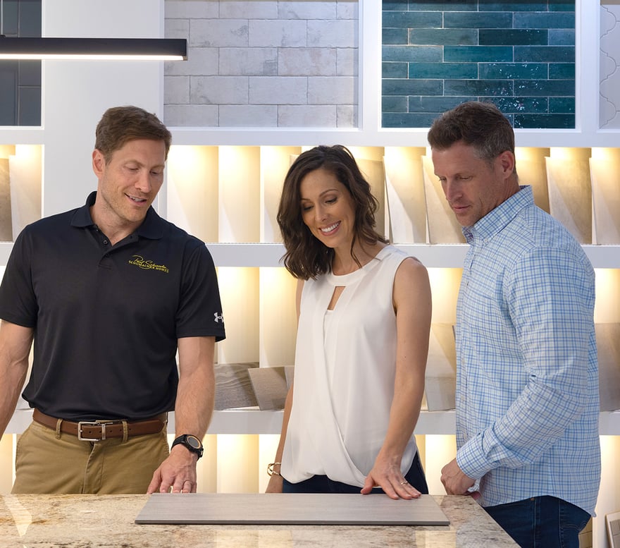 A consultant in a design studio assisting a couple in making selections. 
