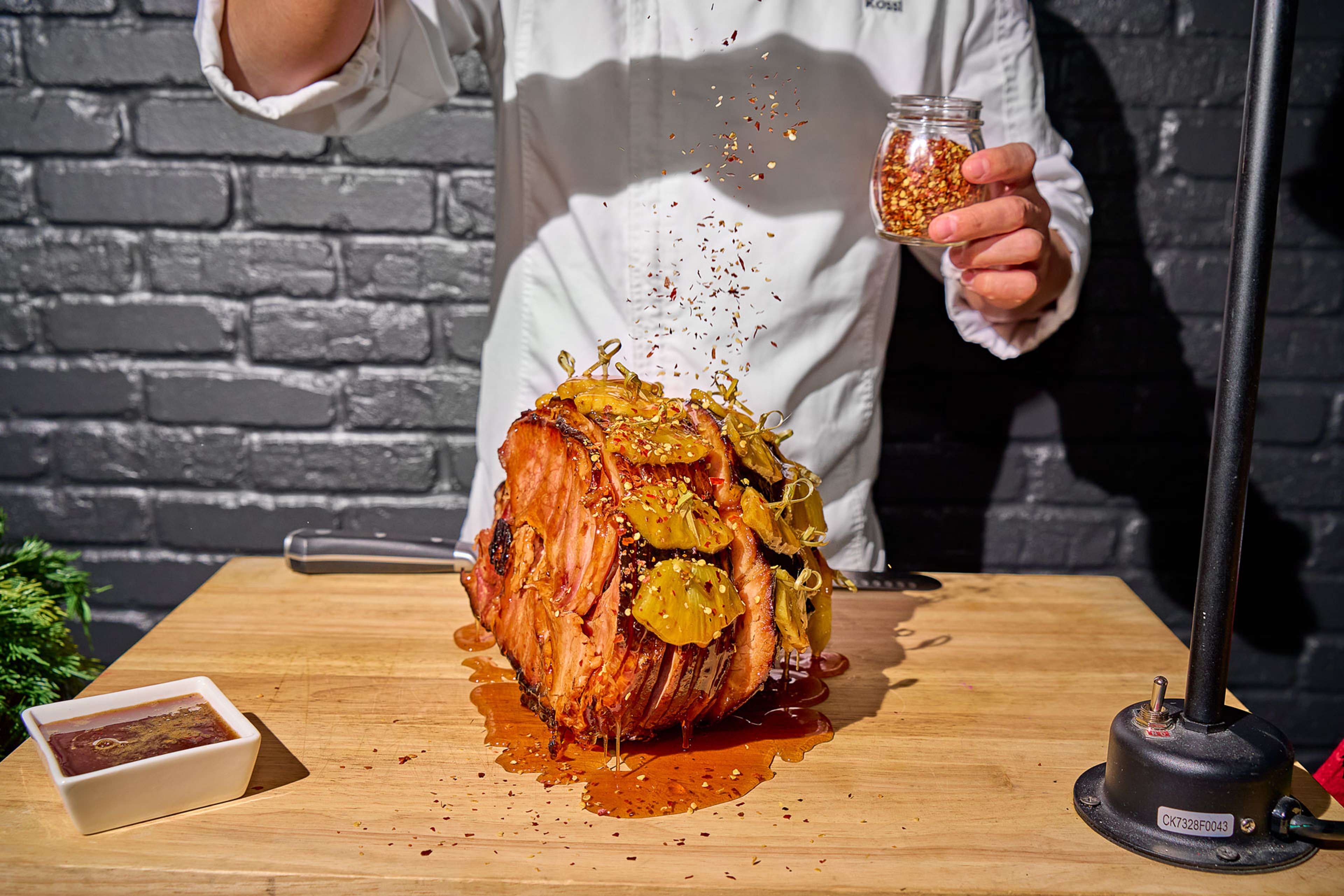 Chef carving a glazed ham