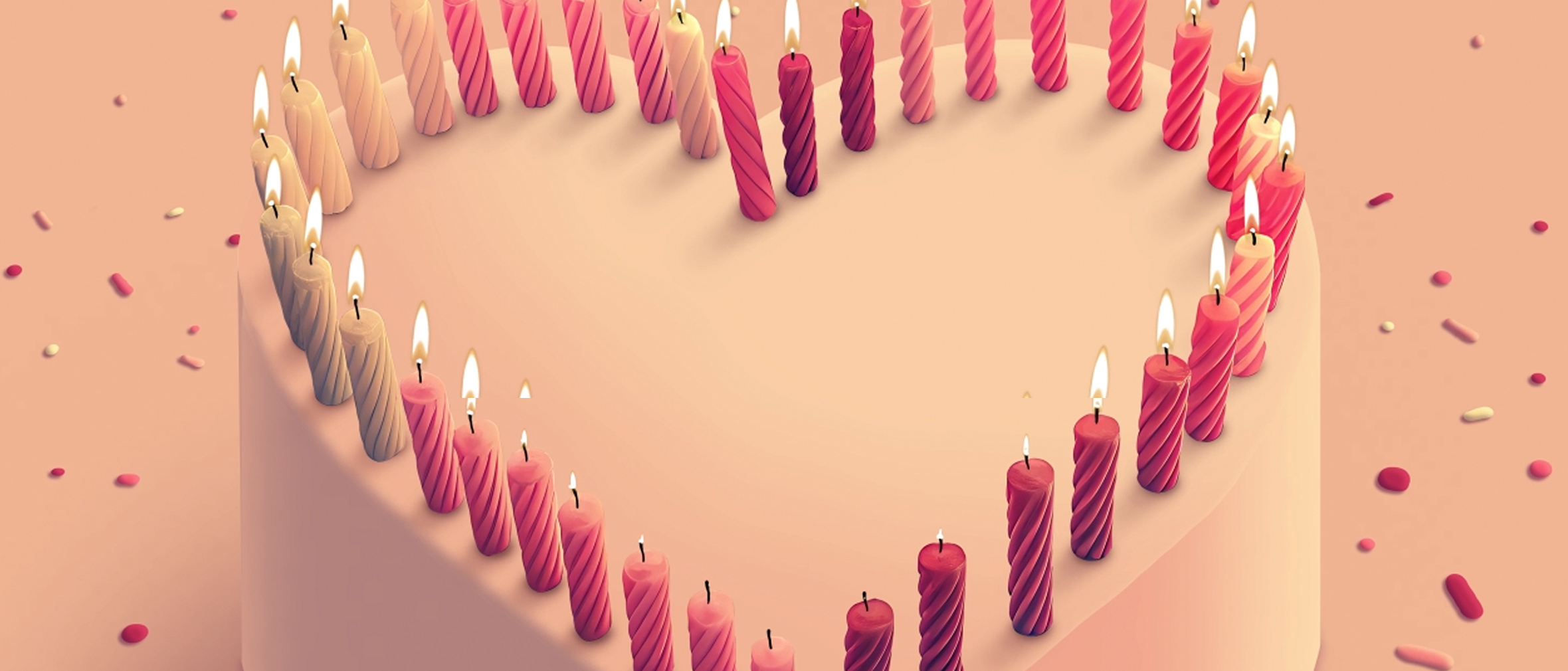 Birthday candles in the shape of a heart on cake