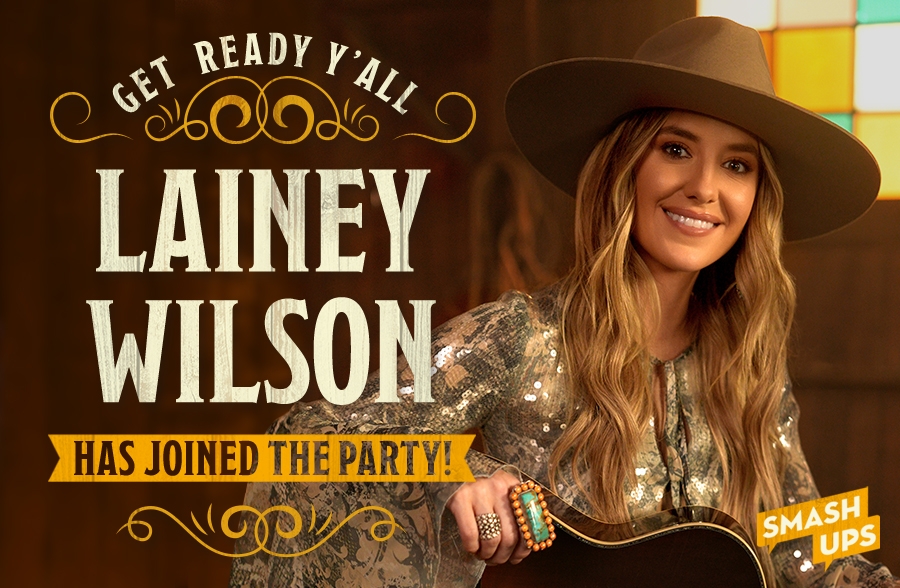 Lainey Wilson singing Happy Birthday and playing a guitar.