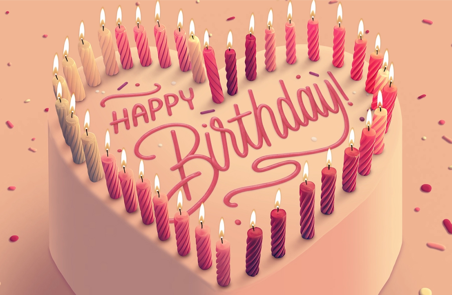 Birthday candles in the shape of a heart on cake