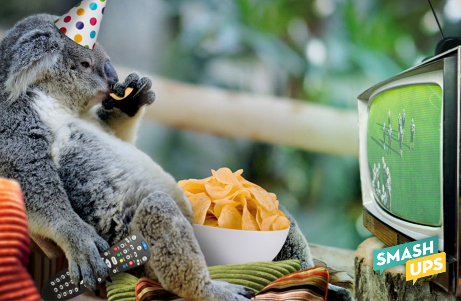 A koala wearing a party hat, eating a bowl of potato chips, watching a football game on a tube tv.