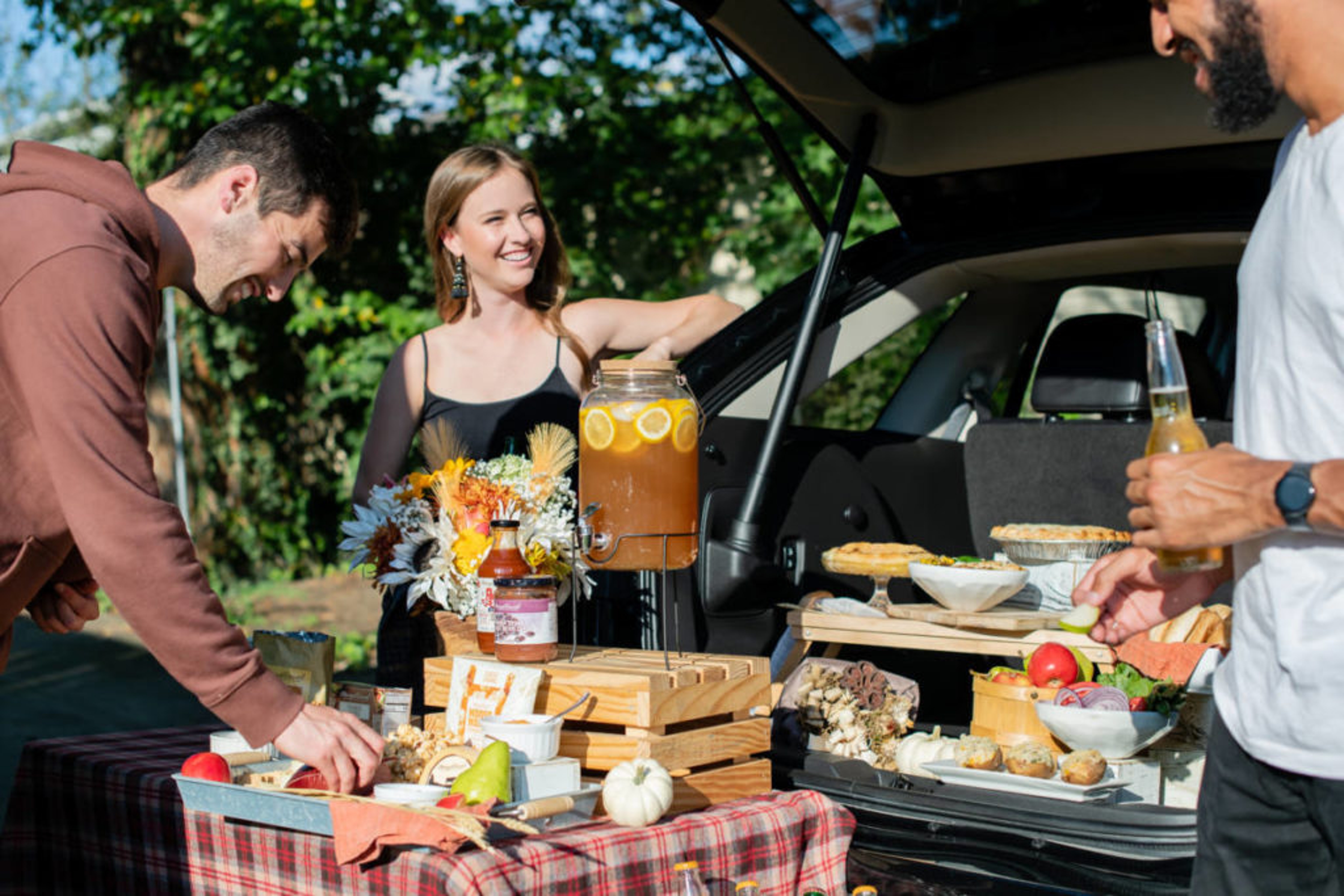 Outdoor tailgate party with a spread of snacks.