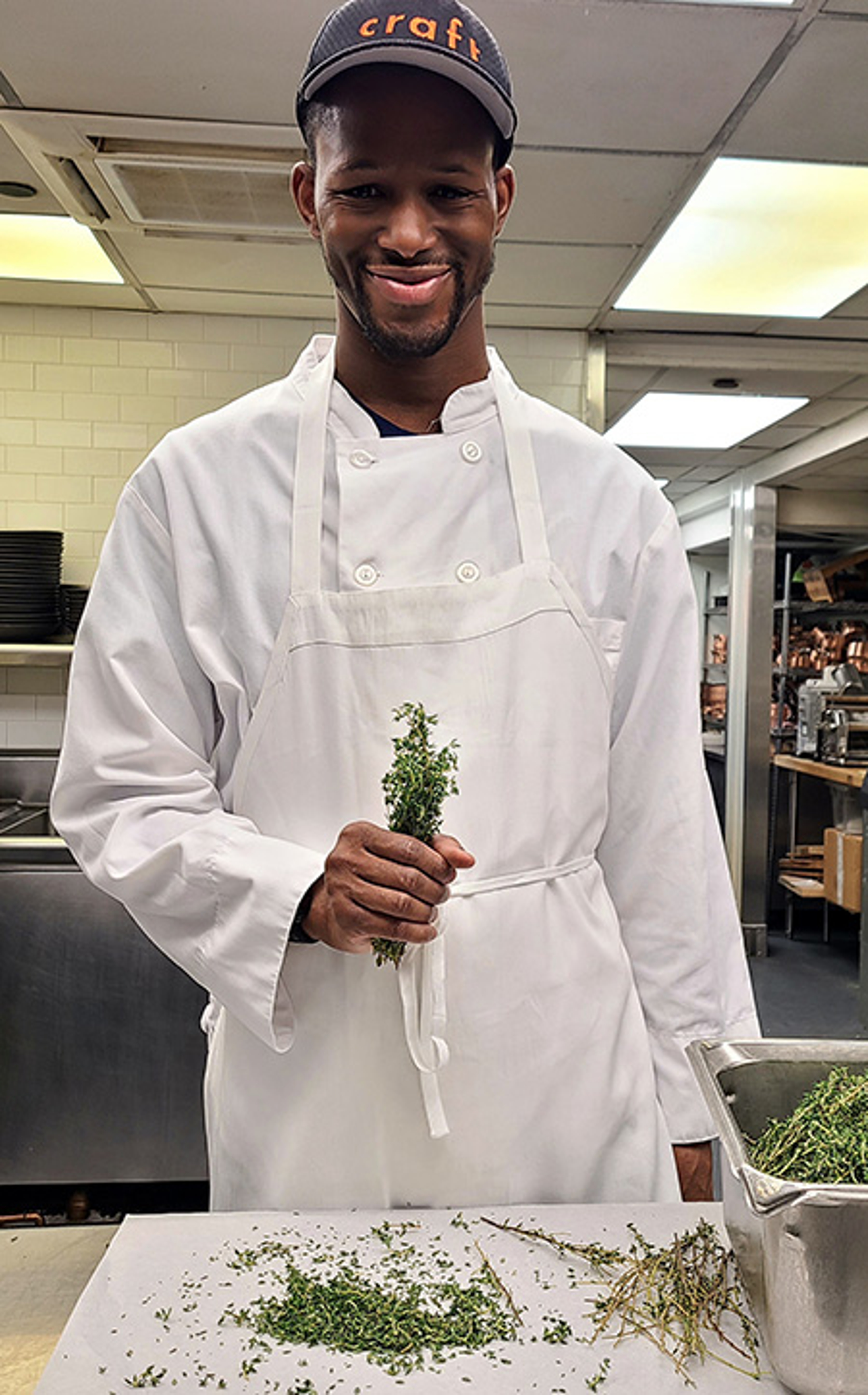 Photo of Manny Irick in the kitchen of restaurant. He was hired through Smile Farms, which helps createjobs for people with disabilities