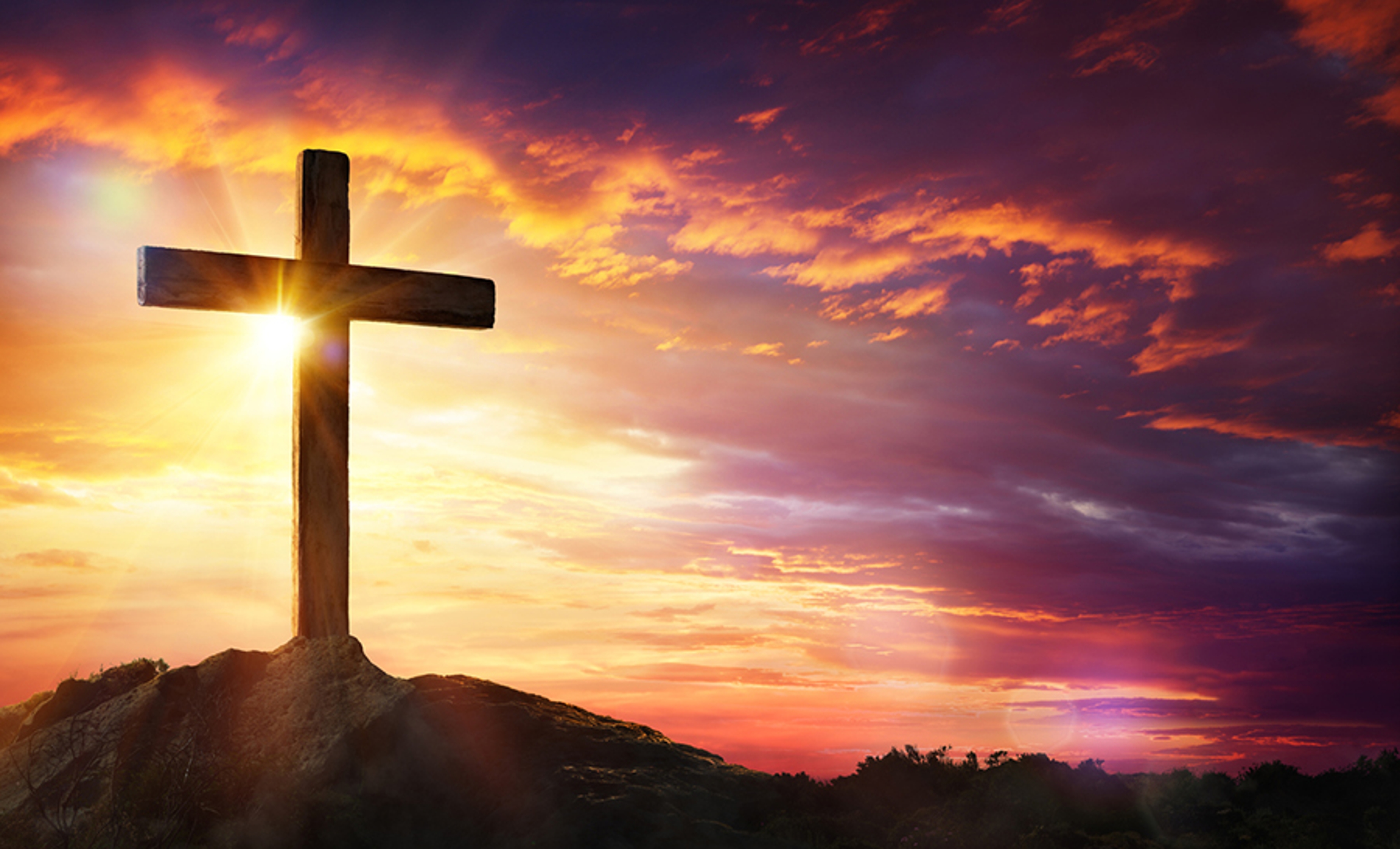 Easter Facts with a Cross At Sunset With Sunlight And Orange Clouds