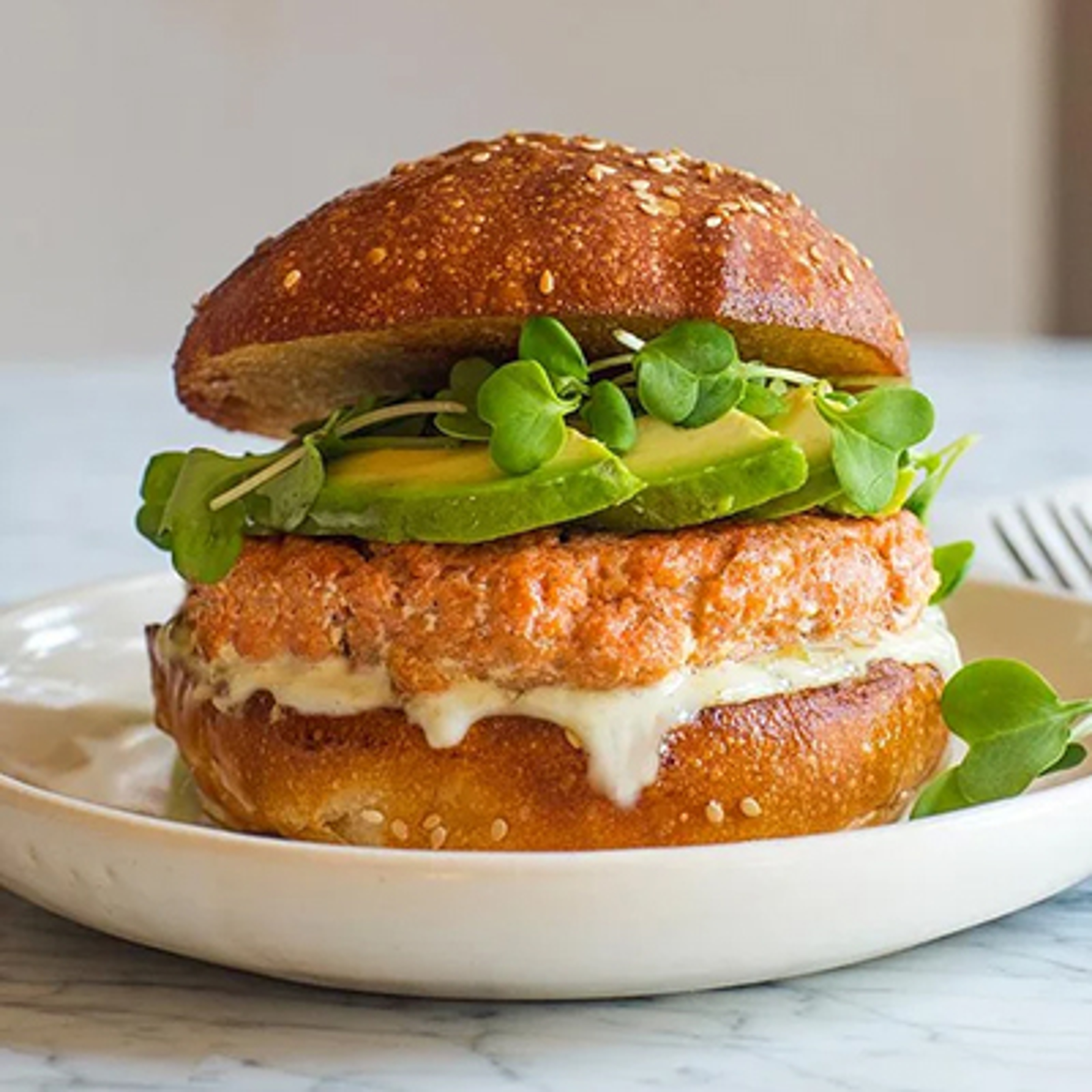 Summer fish recipes with a salmon burger on a plate.