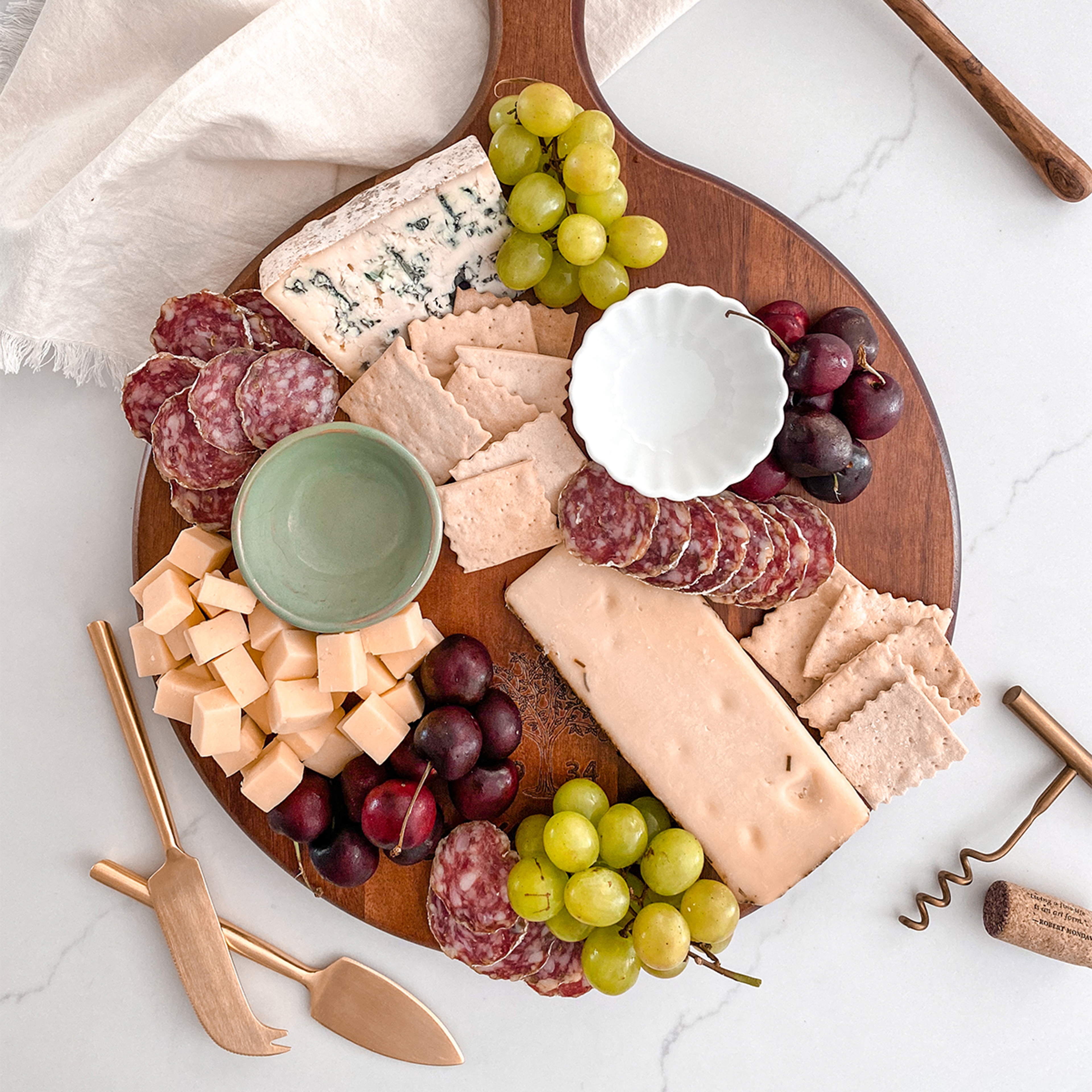 How to create a charcuterie board with meat, cheese, and fruit.